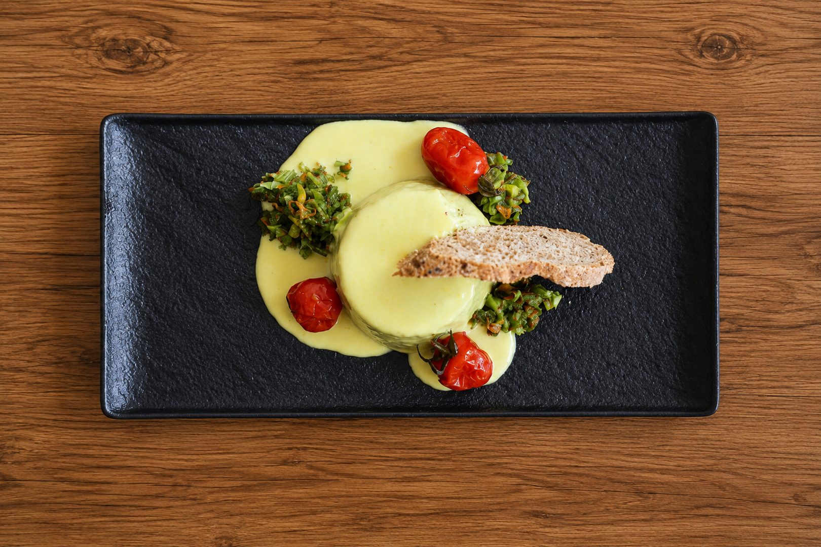 Zucchini Blossom and Courgette Tartlet Served on a saffron-infused Pecorino cheese cream