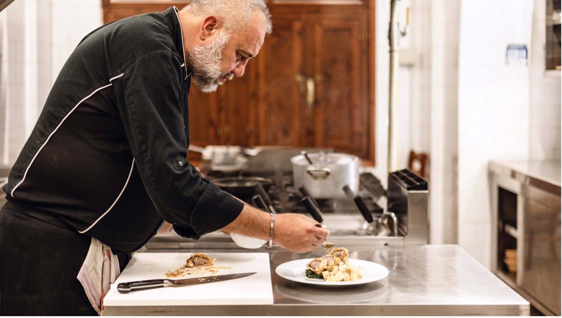Lo chef Gabriele Rosini prepara un piatto nella cucina del ristorante La Miniera a Monterufoli